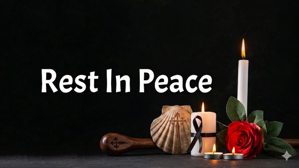 Memorial scene with 'Rest In Peace' text, lit candles, a red rose, shell, and black ribbon on a dark background.