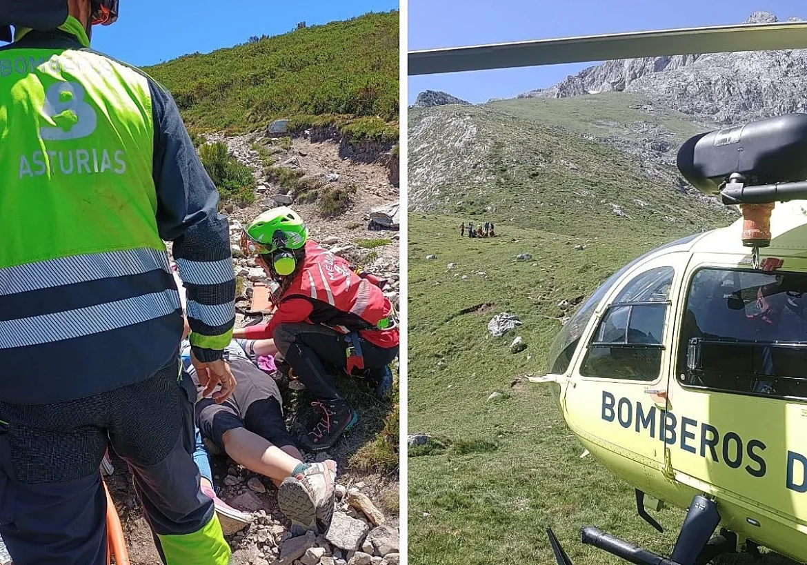 Mountain rescue in rocky terrain: paramedics assist a person on the ground as a sky-blue sky and green hillside loom above (emergency crew in high-visibility jackets). During a mountain aid operation with a helmeted rescuer and onlookers nearby.