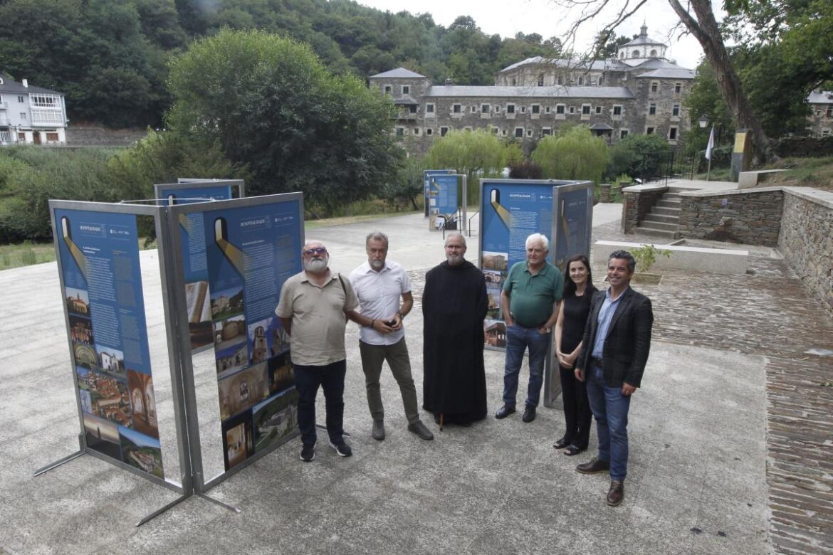 Six adults stand beside blue information panels at an outdoor historical site exhibit.